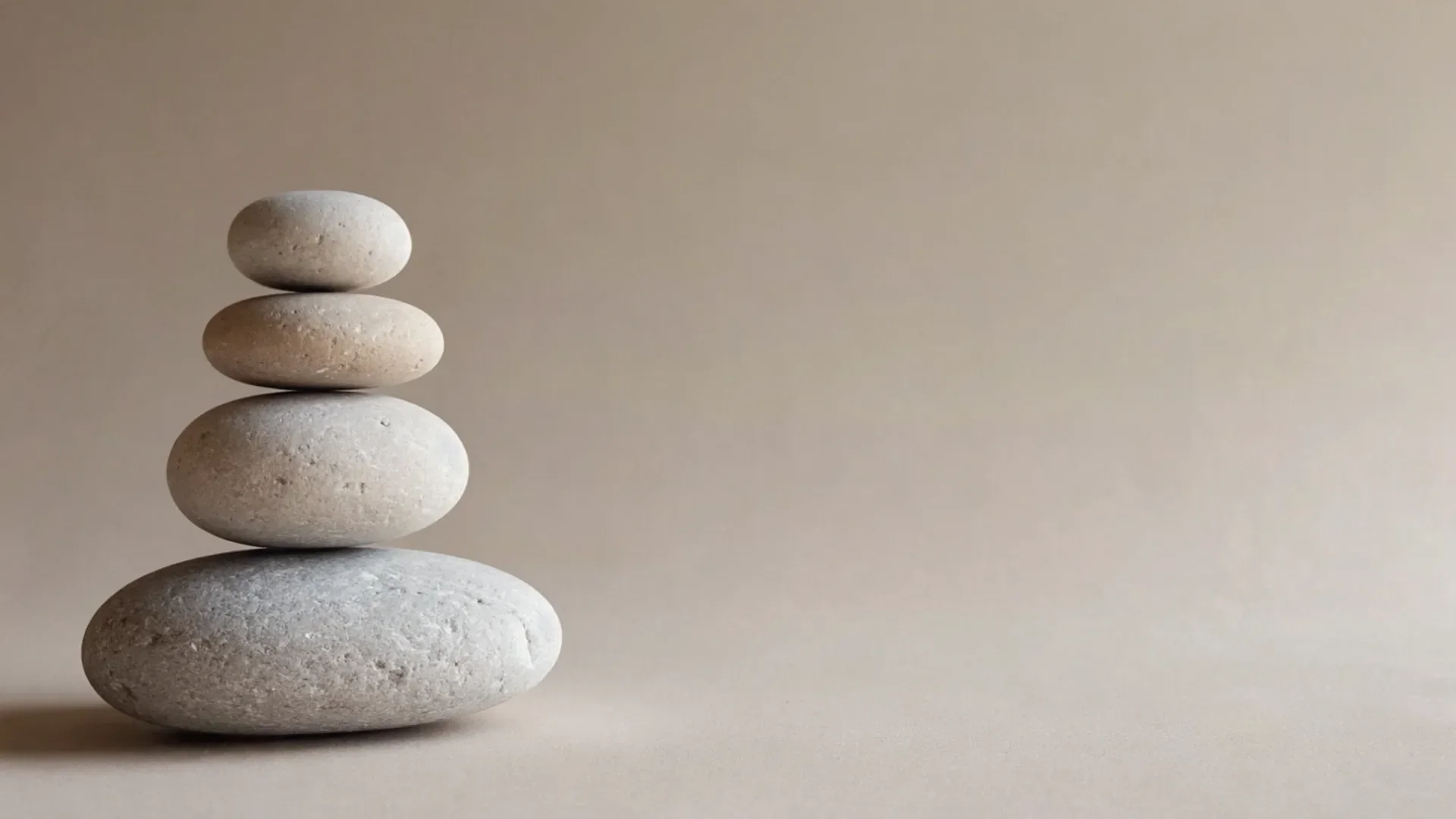 Three balanced stones symbolising the three dimensions of attractiveness: youth, health and beauty